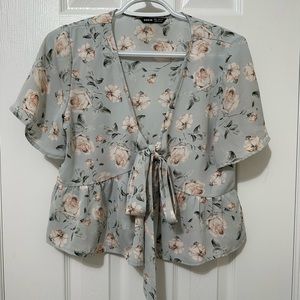 Floral cropped women’s blouse with front tie as bow.
